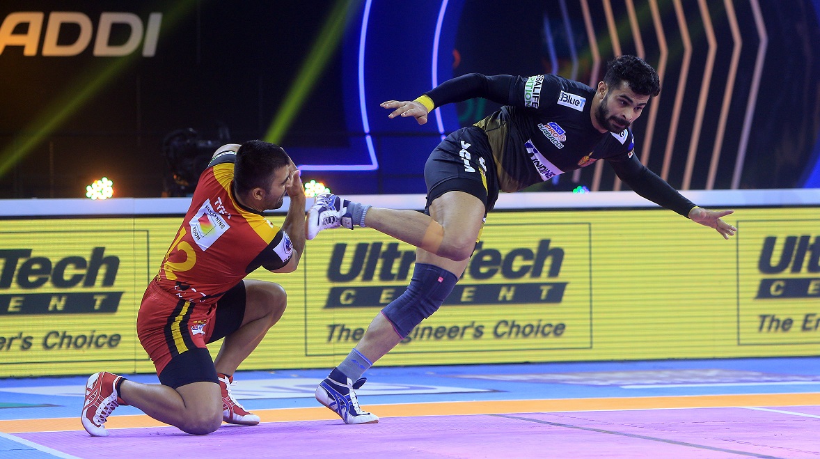 Titans' Ankit Beniwal scores a raid point.