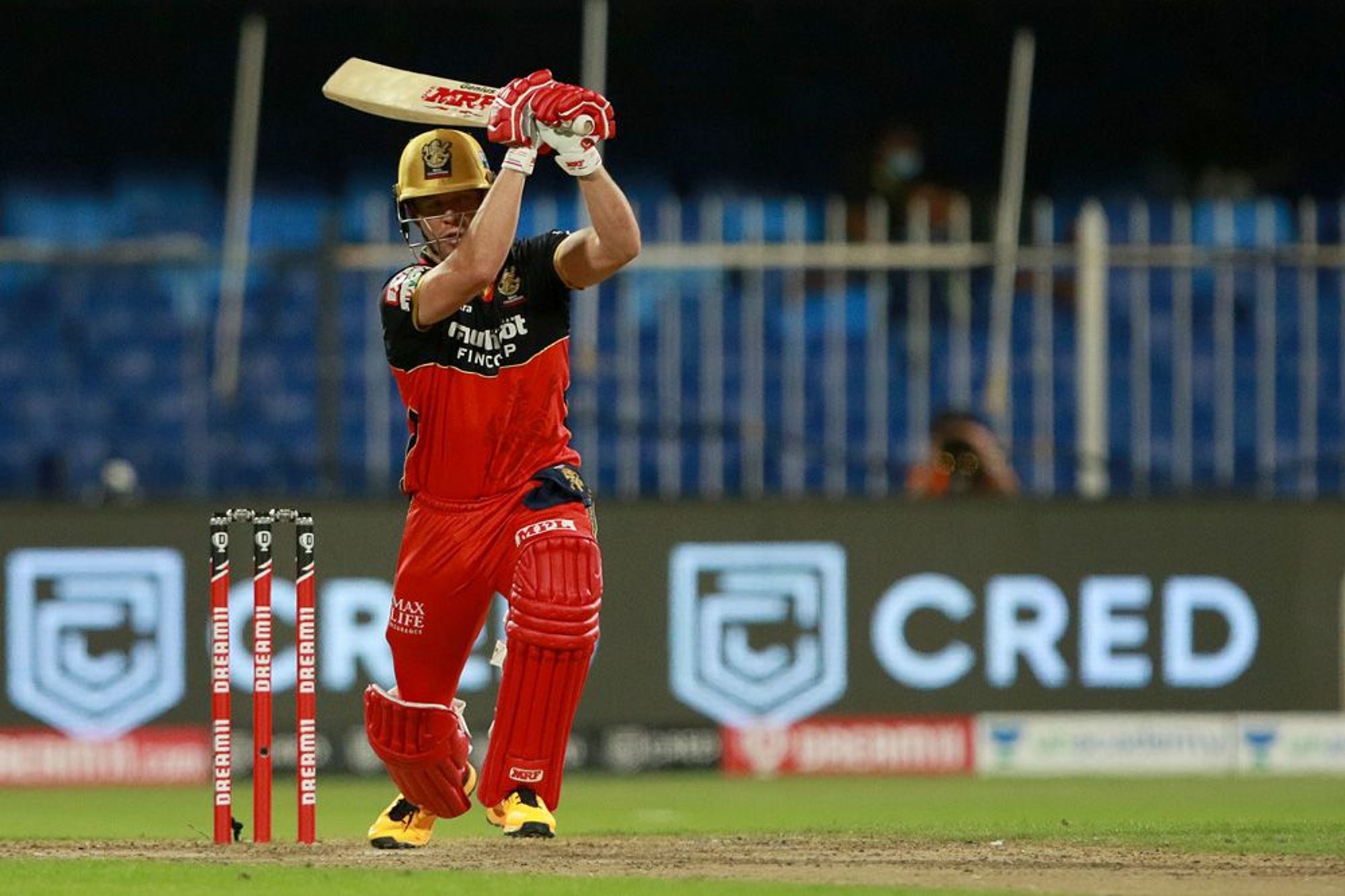 AB de Villiers smashes a straight drive in a game against KKR