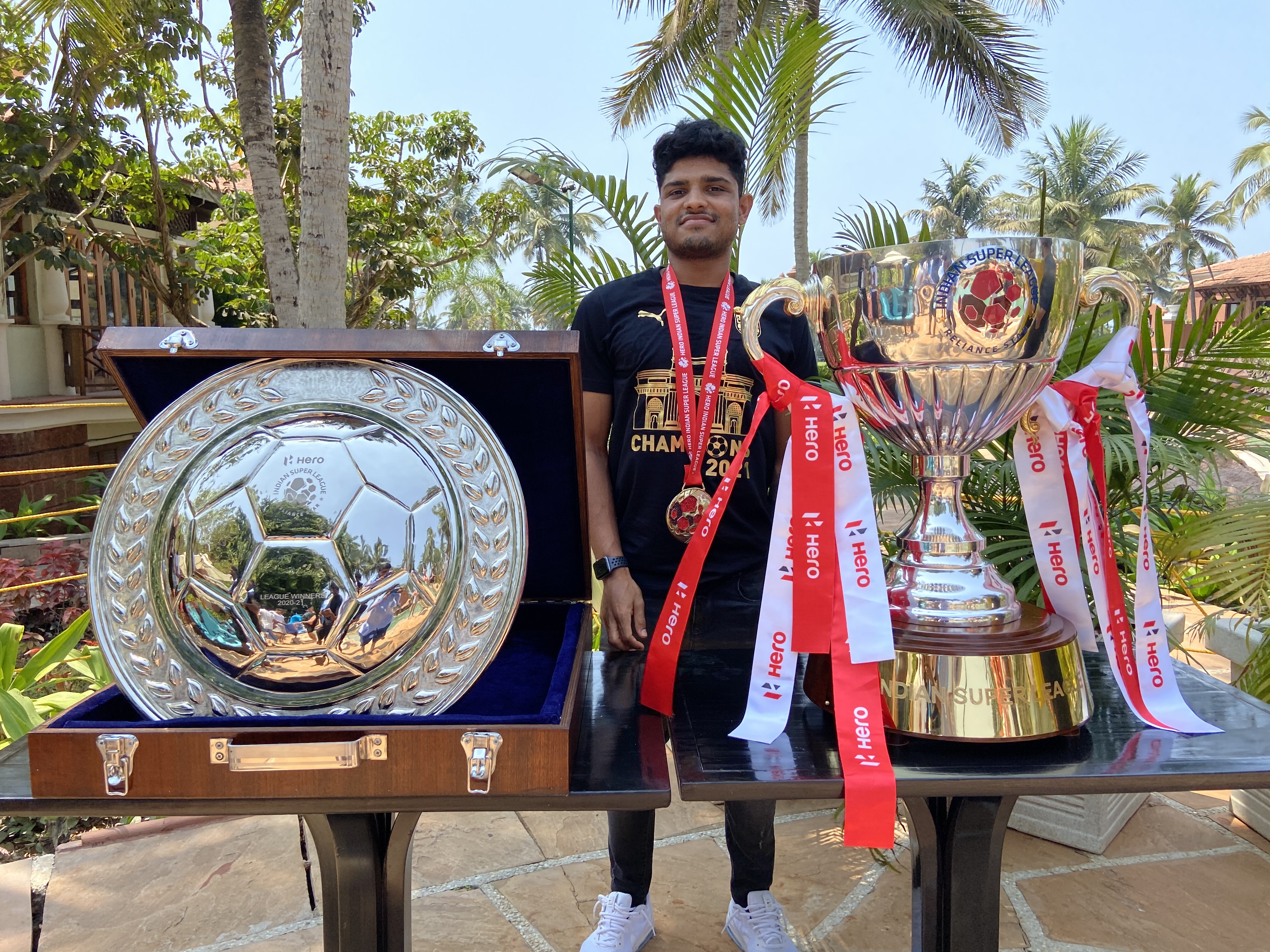 Amey Ranawade with the 2020-21 ISL League Winners Shield and the ISL Trophy
