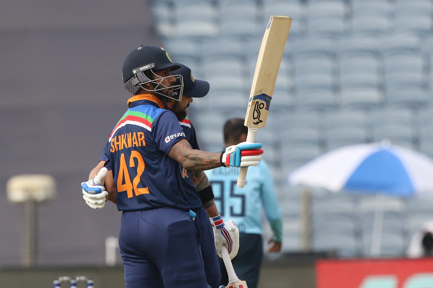 Dhawan raising his bat after reaching fifty against England 