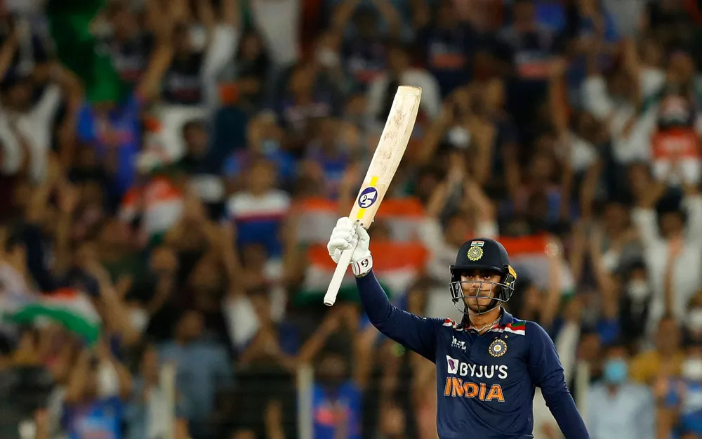 Kishan raising his bat after a well-made fifty on his debut 